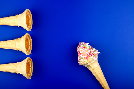 Ice Cream Cones With Hundreds And Thousands On A Bright Blue Background