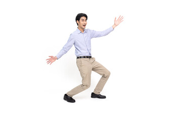 Fototapeta na wymiar Full length portrait of a cheerful excited Asian businessman standing and presenting with two hands isolated over white background