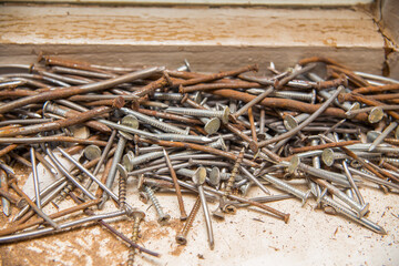 Fototapeta premium A bunch of old nails and screws. Rusty nails, scrap metal.