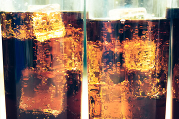 Refreshing Bubbly Soda Pop with Ice Cubes. Cold soda iced drink in a glasses - Selective focus, shallow DOF