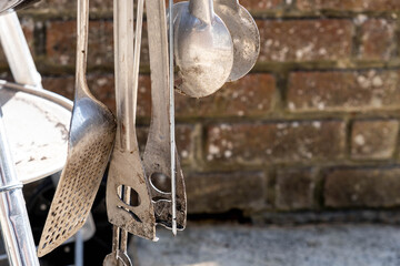A Collection Of Stainless Steel BBQ Cooking Utensils With No People On A Sunny Day