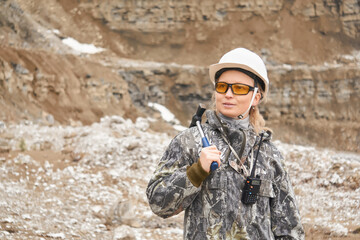 woman geologist on the background of the quarry