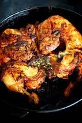 Appetizing grilled chicken in a cast iron pan.