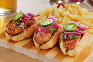 A close up of a pair of chorizo based hot dogs commonly known as 