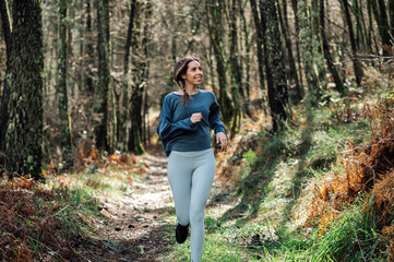 Sporty woman running in forest