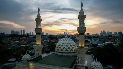Aerial view of the largest Mosque in Jakarta. Ramadan and Eid Concept and noise cloud when sunset or sunrise view. Jakarta, Indonesia, May 4, 2021