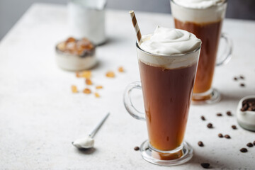 Iced coffee in a tall glasses with cream poured over