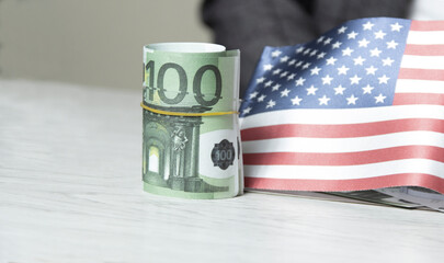 Close up of american flag and euro cash money. euro banknote and United States flag background.