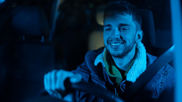 chico joven feliz conduciendo en la noche