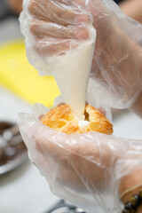 Insert piping tip into each cream Choux Cream puff