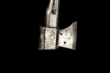Old silver ax with a metal handle. Isolated on black background
