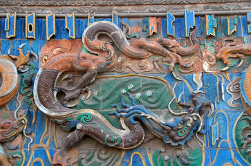 Pingyao in Shanxi Province, China. Detail of the Nine Dragon Wall or Nine Dragon Screen in Pingyao. Pingyao old town is a famous ancient walled city in China.