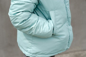 Woman's hand in the pocket of a stylish jacket close-up