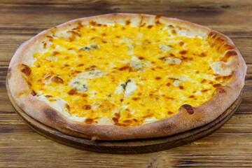 Pizza Four cheese on a wooden background