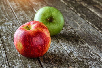 Green and red apples on blackboard or chalkboard background. Bright fruit composition.Red and green apple on old wooden table. Top view with space for your text