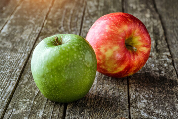 Green and red apples on blackboard or chalkboard background. Bright fruit composition.Red and green apple on old wooden table. Top view with space for your text
