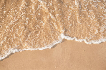 foamy sea water on the beach, golden sand, , sun