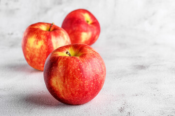  red apples on blackboard or chalkboard background. Bright fruit composition. Close-up on a gray background.