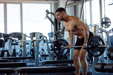 Fototapeta na wymiar Man showing muscles, lifting weights.