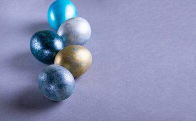 Colorful Easter eggs. Easter background. Minimalistic Easter concept on gray background. Card with copy space for text.