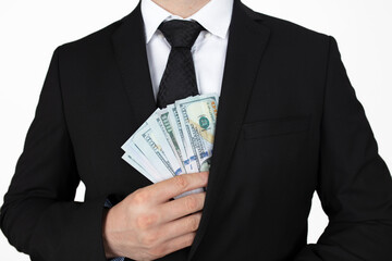 Businessman putting money in suit jacket pocket