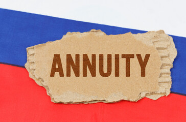 Against the background of the Russian flag lies cardboard with the inscription - ANNUITY
