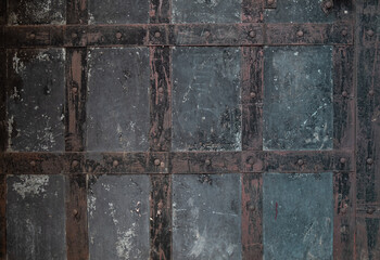 Grunge background black old metal with plates glued together. Lattice square drawing.