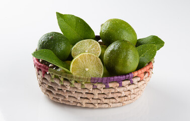 Green lemon fruit in basket with white background