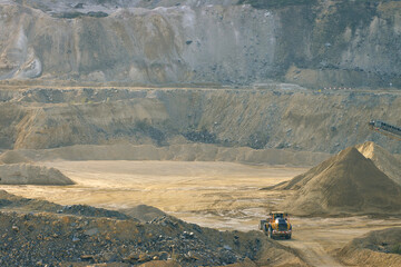 A Large Wheel Loader Dwarfed by the Cliffs in a Huge Quarry. England, UK.