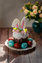 easter eggs and kulich on a plate on the background