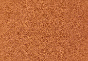 Textured beige background - coating of chocolate on the cake by spraying chocolate with cocoa butter for desserts and sweets