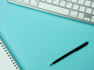 Top view above of magenta workplace with keyboard, paper and pen. Copy space for your text, Flat lay. Office work and office conception.