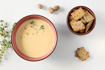 Italian soup with Italian bread on a white table in a beautiful dish