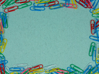 School conception, collorfull school paper clips on a blue background. Back to school. Flatlay, top view, copy space.