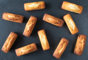 Set of traditional French food - pastries for morning coffee or tea - financier cake on a black...