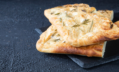 Italian bread - traditional two pieces of focaccia. Focaccia consists of flour, olive oil, water, Fleur de sel, sugar and yeast, topped with rosemary and baked in the oven