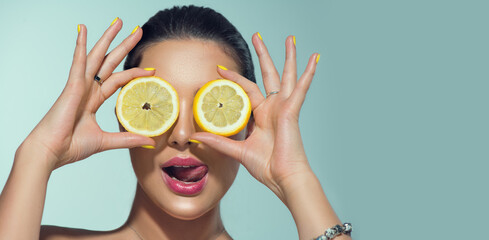 Beautiful healthy girl with slices of lemon citrus fruit, food, cosmetics. Healthy eating, diet....