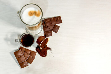 Espresso coffee on white background with open capsule and chocolate.