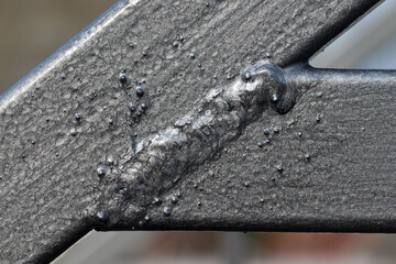 weld, painted metal joint, close-up