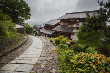 Fototapeta na wymiar footpath,magome,town,japanese,old,post,nakasendo,trail,path,village,history,tourism,destination,twisting,curve,hill,building,stone,traditional,historical,architecture,snaking,tsumago,hike,foot,season,