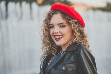 Portrait of happy woman in red beret outdoor