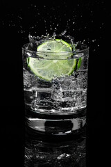 Mojito Lime Water with Splash highball glass gin and tonic on dark background. Food menu restaurant.