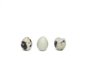 The quail eggs and shells are isolated on a white background