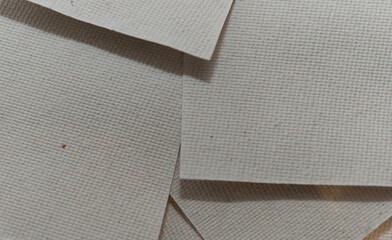 overlapping swatches of light warm grey textured paper 