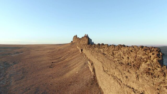 Aerial Shot Of Famous Shiprock Mountain Against Sky, Drone Ascending Forward Towards Popular Landmark In Desert