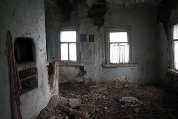 room with stove in an abandoned Ukrainian hut