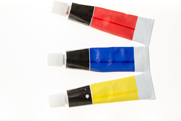 12 ml tubes of red, blue, and yellow acrylic paint on white