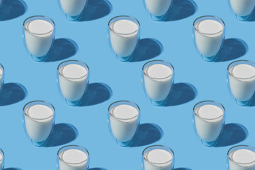 World Milk Day. Pattern on a blue background. A glass of milk. Pattern.