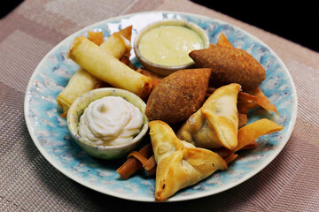meddle eastern food, lebanese arabic food speciality deep fried hot mezze selection includes spinach fatayer, cheese rolls and lamd kebbe