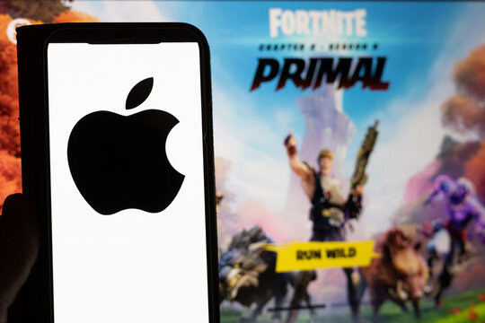 Phone with apple logo and Epic Games Fortnite on a screen in the background referring to the current litigation between Epic Games and Apple